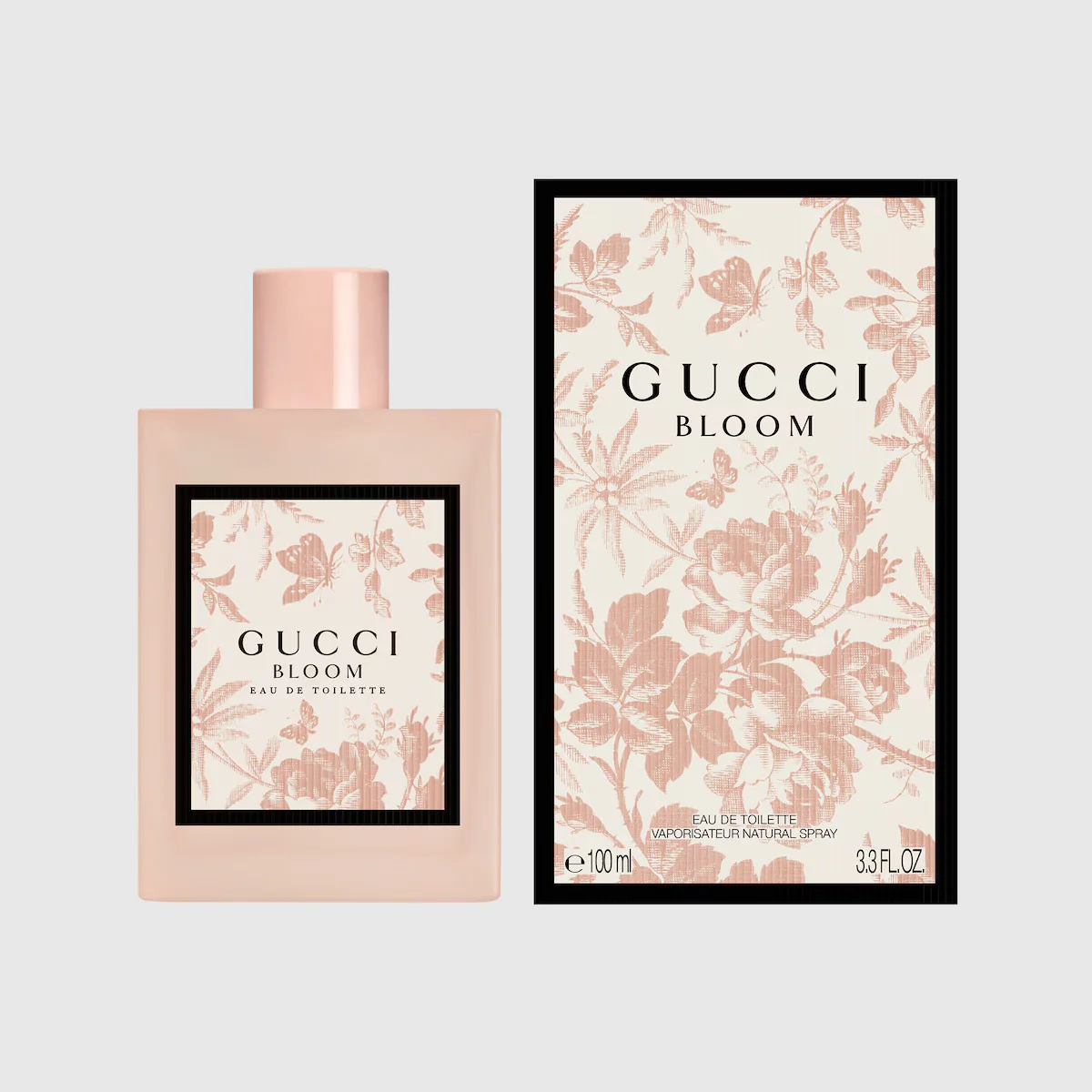 Gucci Bloom Eau de Toilette 100ml pink bottle beside its cream Herbarium-print box — official brand image