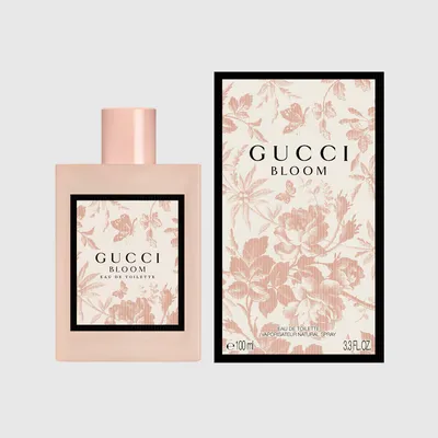 Gucci Bloom Eau de Toilette 100ml pink bottle beside its cream Herbarium-print box — official brand image